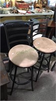 Pair of metal barstools that swivel and have a
