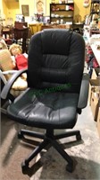 Black office desk chair, has height adjustment