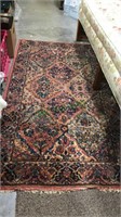 Oriental rug with blues and reds, shows good age,
