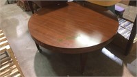 Round coffee table with brass caster feet,