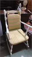 White rocking chair with cushion seat in a