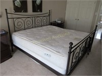 King sized bed with wrought iron headboard