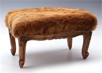 A HIDE COVERED COUNTRY FRENCH STYLE FOOT STOOL
