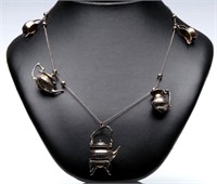 A STERLING SILVER NECKLACE WITH TEAPOT CHARMS