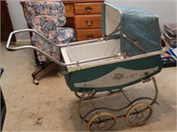 Green metal baby buggy (torn cover)