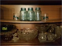 Shelves of pressed glass, crystal, mason jars and