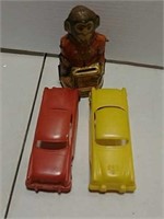 Tin monkey bank and 2 toy cars