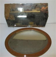 Oval beveled mirror in oak frame. Frame measures