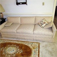 Tan upholstered sofa couch with print