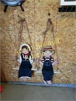Two decorative wood swing figures