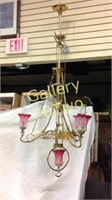 Antique brass chandelier with cranberry glass