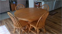 Round oak dinner table and four match chairs