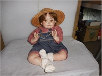 Doll in Bibs and Straw Hat playing strings