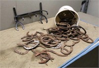 Bucket of Horse Shoes and Coat Rack