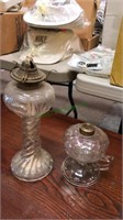 Two antique glass oil lamps, one has the font,