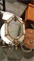 Ornate brass wall mirror with candle sconces,