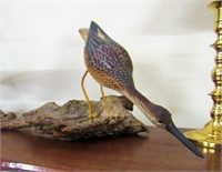 Hand Painted Shore Bird Decoy resting on driftwood