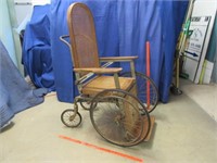 antique caned wheel chair - early 1900's era