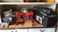Shelf of tools includes cordless drills, levels,