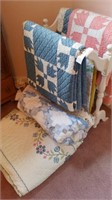 Group of six quilts and rack