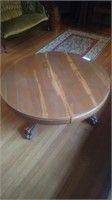 Round oak pedestal coffee table with claw feet