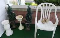 Plastic lawn chair & artificial lit trees