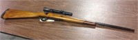 Bolt action rifle with weaver scope, no markings