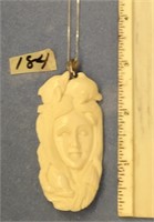 2 3/4" ivory carving of a mermaid and dolphins on