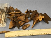 Bag of fossilized ivory pieces and artifacts    (a