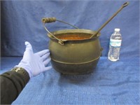 antique cast iron pot with iron ladle