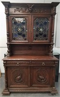 LARGE FIGURAL HUNT CABINET W STAINED GLASS DOORS