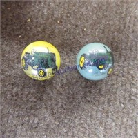 Two John Deere marbles