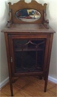 Mahogany curio cabinet with beveled oval mirror
