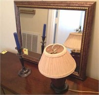 Beveled mirror, candle, small lamp