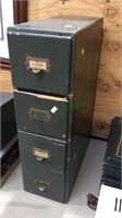 Old four drawer wood file drawer filled with