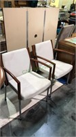 Pair of modern armed office chairs with the beige