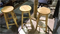 Three matching wooden stools, 24 inches tall