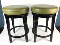Two swivel bar stools used