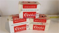 Empty Coors beer cans in cardboard carry cases