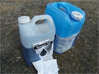 Half jug of Tracker Xp and water jug