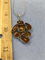 7 piece amber pendent on a sterling silver chain (