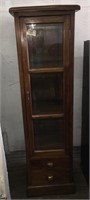 A dainty solid wood and glass display cabinet with
