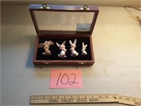Collection of bunnies in a wooden case by Domain