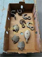 Assorted cast hooks, pulley, brackets