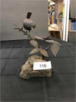 Metal Bird Sculpture On Lava Rock