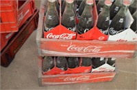 Two wooden Coca-Cola crates with 16 oz. bottles