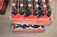 Two wooden Coca-Cola crates with 16 oz. bottles