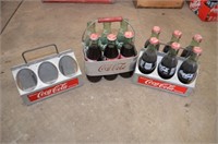 Three aluminum six pack Coca Cola carriers