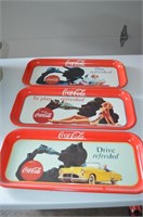 Three Coca-Cola trays