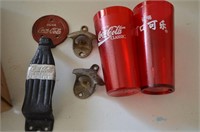 Coca-Cola openers, door handle, and two red cups